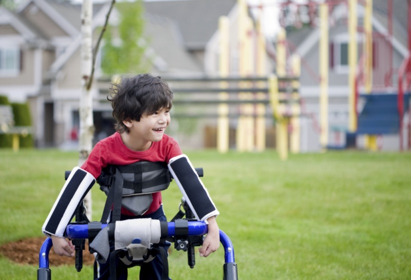 Disabled boy trying to walk on grass