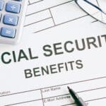 social security benefits form with calculator and glasses