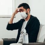 covid-19 and quarantine concept. Sick man with headache symptom