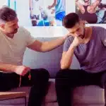 Young physiotherapist cheering up disabled patient. get disability if you are unemployed